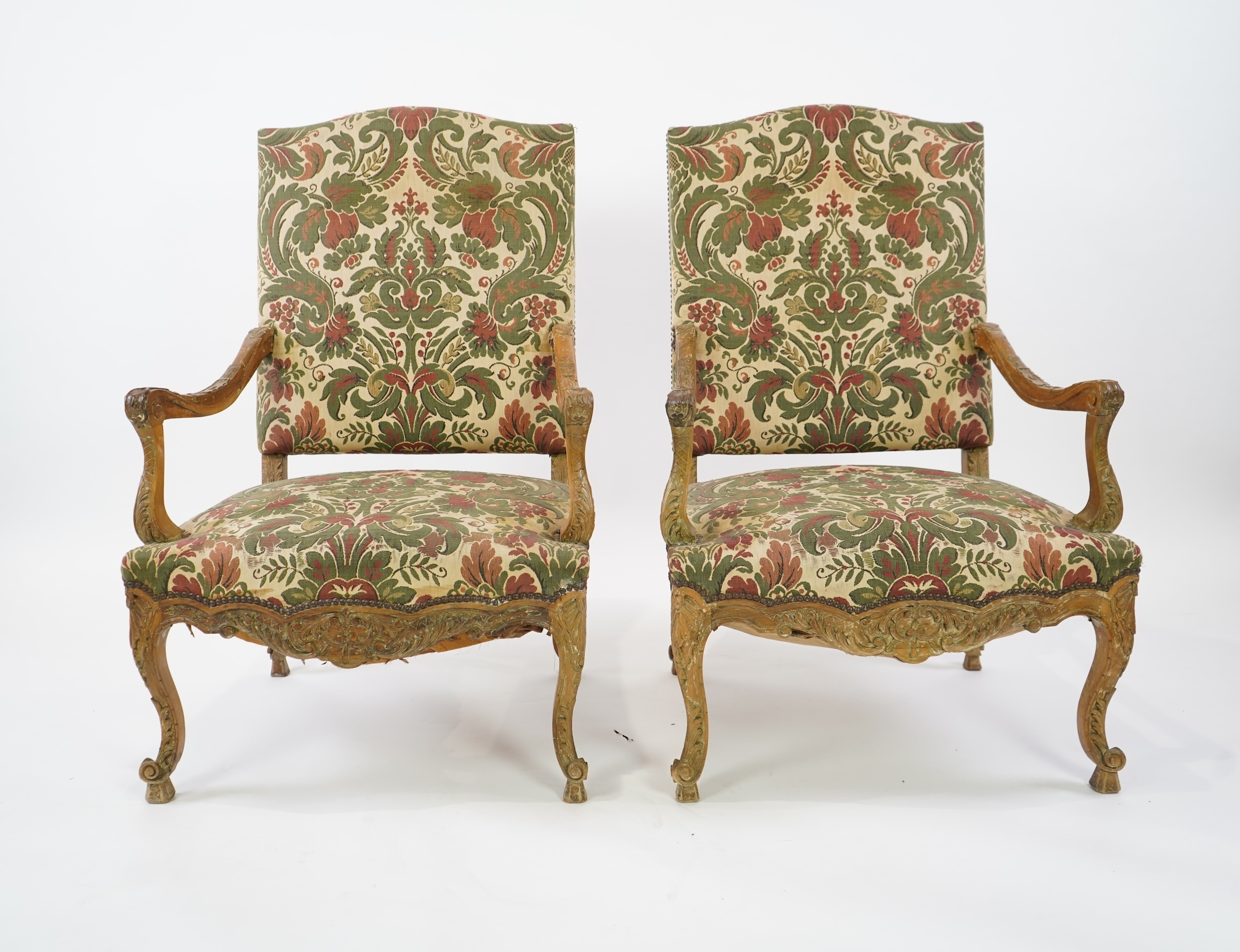 A pair of 19th century Louis XV style carved walnut grand fauteuil, with machined polychrome floral upholstery, outswept arms on cabriole legs, 74cm wide, 66cm deep, 116cm high, Provenance: The late Kenneth Turner (1936-